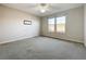 Well-lit bedroom with ceiling fan and carpet flooring at 349 Alcove Dr, Groveland, FL 34736