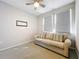 Light and airy bedroom with a sofa and two windows at 349 Alcove Dr, Groveland, FL 34736
