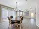 Bright dining area with round table and four chairs near sliding doors at 349 Alcove Dr, Groveland, FL 34736