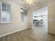 Open dining area with wood-look flooring and a view of the kitchen at 349 Alcove Dr, Groveland, FL 34736