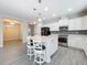 Modern kitchen featuring white cabinets, stainless steel appliances, and a large kitchen island at 349 Alcove Dr, Groveland, FL 34736