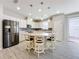 Modern kitchen with white cabinetry, stainless steel appliances, and an island with seating at 349 Alcove Dr, Groveland, FL 34736