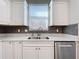 Modern kitchen sink with white cabinets and gray backsplash at 349 Alcove Dr, Groveland, FL 34736
