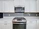 Stainless steel stove and microwave in modern kitchen at 349 Alcove Dr, Groveland, FL 34736