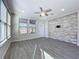 Spacious living room with wood-look floors and stone accent wall at 349 Alcove Dr, Groveland, FL 34736