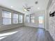 Spacious living room with wood-look floors and stone accent wall at 349 Alcove Dr, Groveland, FL 34736