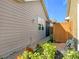 Landscaped side yard with wooden gate and brick pathway at 349 Alcove Dr, Groveland, FL 34736