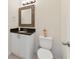 Clean bathroom with dark countertop and white cabinets at 470 Lake Shore Pkwy, Davenport, FL 33896