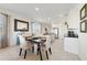 Dining room with a dark wood table, four chairs, and views to the living room and kitchen at 470 Lake Shore Pkwy, Davenport, FL 33896