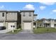 Two-story townhome with a two-car garage and a small front yard at 470 Lake Shore Pkwy, Davenport, FL 33896