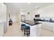 Modern kitchen with white cabinets, granite countertops, and a large island with seating at 470 Lake Shore Pkwy, Davenport, FL 33896