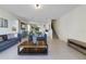 Open living room with gray sofas, a coffee table, and views to the kitchen and dining area at 470 Lake Shore Pkwy, Davenport, FL 33896