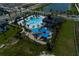 Aerial view of community pool, playground, and shaded seating areas at 5069 Rain Shadow Dr, Saint Cloud, FL 34772