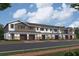 Exterior of townhouses featuring gray and white siding, and brick driveways at 5084 Rain Shadow Dr, St Cloud, FL 34772