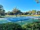 Well-maintained tennis courts with green surrounding at 6963 Northwich Dr, Windermere, FL 34786