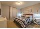 King bedroom with TV, large window, and modern decor at 7400 Oakmoss Loop, Davenport, FL 33837