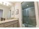 Bathroom with granite countertop, gray cabinets, and shower at 7400 Oakmoss Loop, Davenport, FL 33837