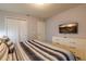 King bedroom with double doors and dresser at 7400 Oakmoss Loop, Davenport, FL 33837