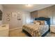 Bedroom with a blue upholstered bed, patterned bedding, and wall art at 7400 Oakmoss Loop, Davenport, FL 33837