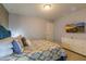 Bedroom with TV, blue upholstered bed, and patterned bedding at 7400 Oakmoss Loop, Davenport, FL 33837