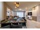 Elegant dining room features a large table and modern light fixtures at 7400 Oakmoss Loop, Davenport, FL 33837