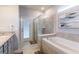Elegant bathroom with soaking tub, walk-in shower, and granite countertops at 7400 Oakmoss Loop, Davenport, FL 33837