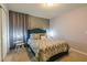 Bedroom with a queen-size bed and patterned bedding at 7400 Oakmoss Loop, Davenport, FL 33837