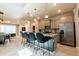 Modern kitchen with island, stainless steel appliances, and stylish light fixtures at 7400 Oakmoss Loop, Davenport, FL 33837