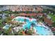 Resort-style pool with water slide, surrounded by palm trees and homes at 7400 Oakmoss Loop, Davenport, FL 33837