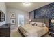 Bright bedroom with a king-size bed, en-suite bathroom access, and stylish decor at 7400 Oakmoss Loop, Davenport, FL 33837