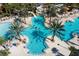 Large community pool with plenty of lounge chairs and palm trees at 7400 Oakmoss Loop, Davenport, FL 33837