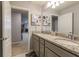 Bathroom with granite countertop and double vanity at 7400 Oakmoss Loop, Davenport, FL 33837
