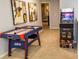 Game room featuring air hockey, arcade game, and artwork at 7400 Oakmoss Loop, Davenport, FL 33837