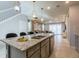 Modern kitchen island with granite countertops and sink at 7400 Oakmoss Loop, Davenport, FL 33837