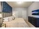 Spacious bedroom with a large bed, accent wall, and plenty of storage at 7400 Oakmoss Loop, Davenport, FL 33837