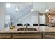 Kitchen island with granite countertops and double sink at 7400 Oakmoss Loop, Davenport, FL 33837