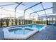 View of the pool and spa from the patio at 7400 Oakmoss Loop, Davenport, FL 33837