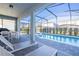 Relaxing pool and spa area with patio furniture at 7400 Oakmoss Loop, Davenport, FL 33837