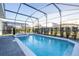 Screened pool and spa with patio and lounge chairs at 7400 Oakmoss Loop, Davenport, FL 33837