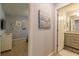 View down hallway to bathroom with vanity and shower at 7400 Oakmoss Loop, Davenport, FL 33837