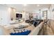 Open living room with modern furniture and a large TV at 7400 Oakmoss Loop, Davenport, FL 33837