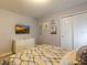 Bedroom with TV, dresser, and patterned bedding at 7400 Oakmoss Loop, Davenport, FL 33837