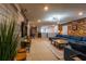 Large game room with sectional sofa, TV, and rustic wood wall at 7400 Oakmoss Loop, Davenport, FL 33837