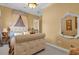 Spacious bedroom with tufted headboard and large mirror at 7440 Aloma Ave, Winter Park, FL 32792