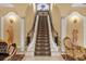 Ornate staircase with wrought iron railing in a luxurious home at 7440 Aloma Ave, Winter Park, FL 32792