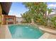 Inviting pool area with a fountain, lush landscaping and built in grill at 7440 Aloma Ave, Winter Park, FL 32792