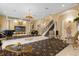 Grand living room with ornate furnishings and a sweeping staircase at 7440 Aloma Ave, Winter Park, FL 32792