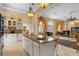 Open kitchen with breakfast bar and views into the living room at 7440 Aloma Ave, Winter Park, FL 32792