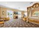 Luxurious main bedroom with large windows, sitting area, and a four-poster bed at 7440 Aloma Ave, Winter Park, FL 32792