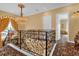 Elegant upstairs hallway with chandelier and ornate railing at 7440 Aloma Ave, Winter Park, FL 32792
